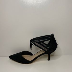 Woman’s black sparkly heels